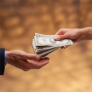Woman counting money copyright Jose Luis Pelaez, Inc, Blend Images, Getty Images