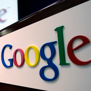 The Google logo is seen on a podium and projected on a screen at Google headquarters in Mountain View Califorina Paul Sakuma AP