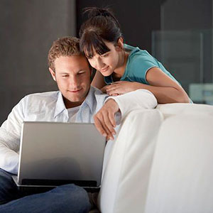 Couple with laptop copyright Corbis
