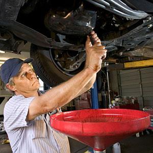 Man changing oil copyright Ron Chapple, Getty Images