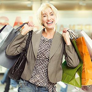 Woman in mall with shopping bags copyright Paul Bradbury, OJO Images, Getty Images