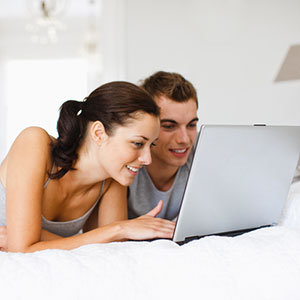 Couple with laptop copyright Daly and Newton, OJO Images, Getty Images