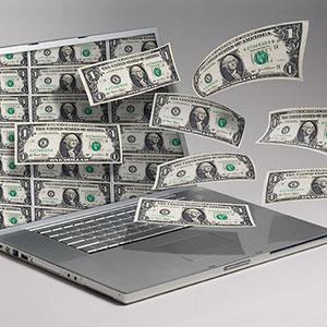 Money and computer copyright Angel Muniz, Jupiterimages