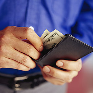 Image: Man Taking Money Out of Wallet © NULL/Corbis