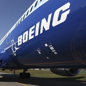 File photo of the Boeing Co. logo seen on the fuselage of a 787 Dreamliner (© SeongJoon Cho/Bloomberg via Getty Images)