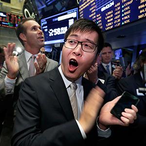  CEO of 58.com Inc., Jinbo Yaoon applauds as his company's stock begins trading during its IPO on the floor of the New York Stock Exchange on Thursday, Oct. 31, 2013. © Richard Drew/AP