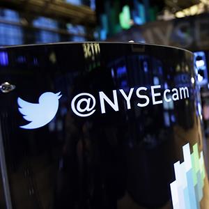 Credit: © Richard Drew/AP
Caption: A Twitter logo an updated phone post is shown the floor of the New York Stock Exchange Monday, Nov. 4, 2013, in New York