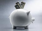 Image: Money in Piggy Bank (© Flame/Corbis)