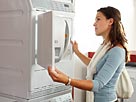 Image: A woman looking at a washing machine in an electrical shop © altrendo images/Stockbyte/Getty Images