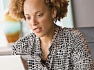 Image: African-American woman shopping online (© Ariel Skelley/Blend Images/Getty Images)