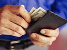 Image: Man Taking Money Out of Wallet © NULL/Corbis