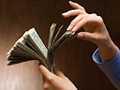 Image: Woman counting money (© Jose Luis Pelaez, Inc/Blend Images/Getty Images)