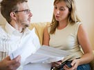 Image: Couple with paperwork (© Christina Kennedy/Brand X/Corbis)