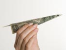 Image: Paper airplane made of money (© Tetra Images/Corbis)