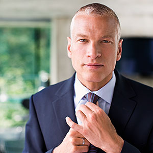Logo: Businessman adjusting necktie Tom Merton, OJO Images, Getty Images