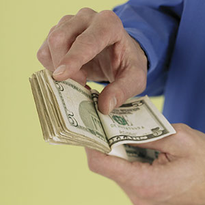 Logo: Couple counting money (Jose Luis Pelaez Inc, Blend Images, Getty Images)