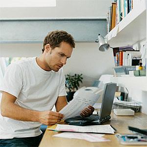 Logo: Serious Man Examining a Bill (Digital Vision, Getty Images)