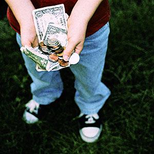 Logo: Boy holding allowance money (Bryan Mullennix/Photodisc/Getty Images)