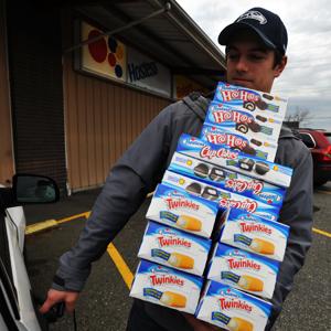 Credit: Philip A. Dwyer/Bellingham Herald/MCT via Getty Images
Caption: Andy Wagar loads Twinkies, Ho-Hos and cupcakes into a van outside the Wonder Bakery Thrift Shop in Bellingham, Washington, on Friday, November 16, 2012