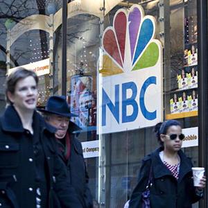 An NBC logo hangs in a window of the NBC Experience store in New York, NY in 2009 (© Daniel Acker/Bloomberg via Getty Images)