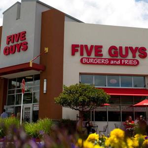 Credit: David Paul Morris/Bloomberg via Getty Images
Caption: A Five Guys Inc. restaurant stands in Dublin, California