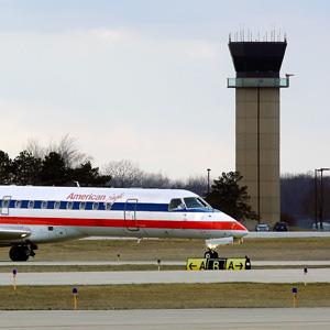 An American Eagle jet taxis to a gate past the control tower after landing at the Abraham Lincoln Capital Airport in Springfield, Ill. on March 12, 2013 (© Seth Perlman/AP)