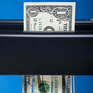 Image: Shredding money (© RubberBall/SuperStock)
