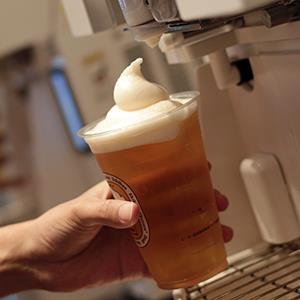 Employees pull frozen froth heads onto cups of Kirin draft beer for their 