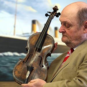 Auctioneer Alan Aldridge holds the violin of Wallace Hartley, the band leader of the Titanic. Matt Cardy/Getty Images