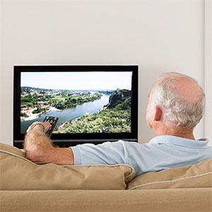 A senior man watching TV © Image Source, Getty Images