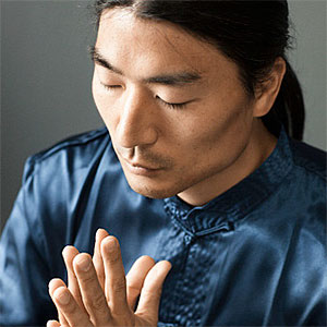 Korean man praying. Copyright: Blend Images, Hill Street Studios, Blend Images, Getty Images