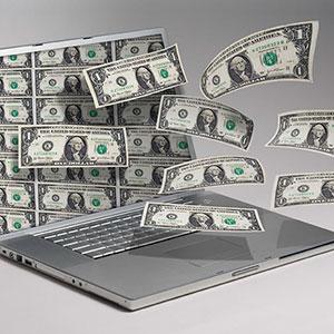 Image: Money and computer. Copyright: Angel Muniz, Jupiterimages.