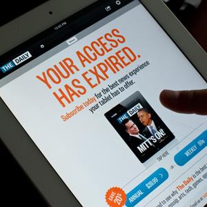 A man reads The Daily in Washington, D.C. on Dec. 3, 2012 © NICHOLAS KAMM/AFP/Getty Images