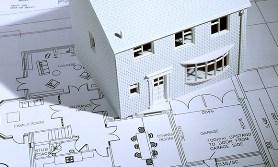 Model house on blueprints (© Image Source/Getty Images)