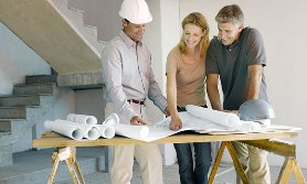 Construction foreman explaining blueprints to couple (© Robert Daly/Getty Images)