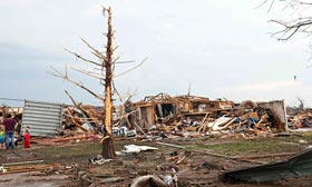 Stripped trees and destroyed houses following a tornado in Moore, Okla. (©Richard Rowe/Reuters)