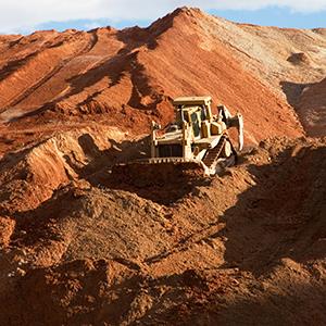 Credit: © Robert Shantz/Alamy
Caption: A Caterpillar bulldozer pushes waste at a Freeport-McMoran copper mine in Arizona