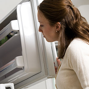 Image: Woman and refrigerator (© Photos.com/Jupiterimages)