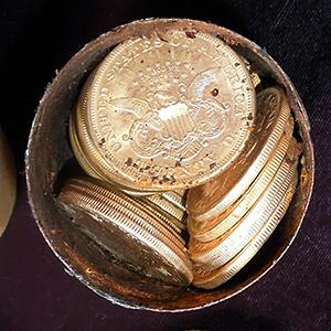Credit: © Saddle Ridge Hoard discoverers via Kagin's, Inc./AP
Caption: One of the six decaying metal canisters filled with 1800s-era U.S. gold coins unearthed in California