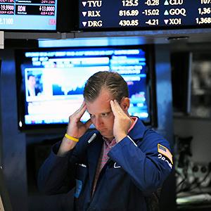 Caption: A trader works on the floor of the New York Stock Exchange
Credit: © Peter Foley/Corbis