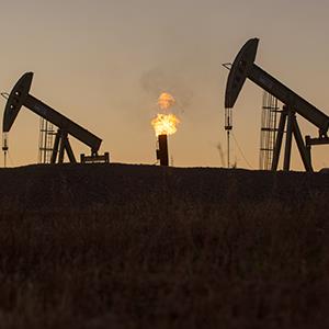 Credit: © Ken Cedeno/Corbis
Caption: A gas flare is seen burning between two pump jacks near Epping, N.D., on Sept 20, 2013