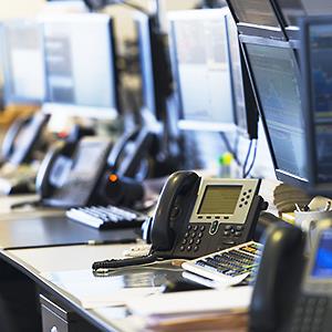 Credit: © Tetra Images/Getty Images
Caption: Empty trading desks with computers and phones
