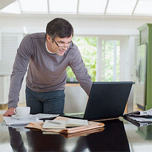 Man looking at laptop © Chris Ryan, OJO Images, Getty Images