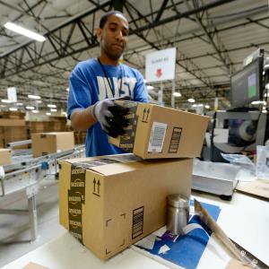 Employee Lamar Roby prepares shipping orders at Amazon's San Bernardino, Calif., Fulfillment Center. Photo by Kevork Djansezian/Getty Images