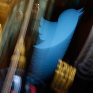 Credit: © Richard Drew/AP Photo
Caption: The Twitter bird logo is on an updated phone post on the floor of the New York Stock Exchange.