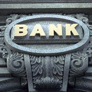 Credit: © Chris Minerva/Getty Images
Caption: A bank sign on a building