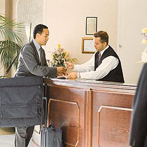 Image: Man at concierge © Comstock, Getty Images
