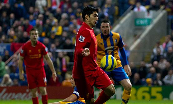 Luis Suarez handles the ball on the way to scoring against Mansfield