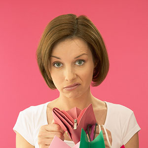 Image: Woman holding empty purse © image100/Corbis