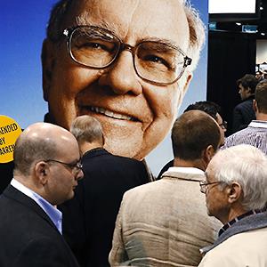Credit: © Rick Wilking/Reuters
Caption: A huge picture of Berkshire Hathaway Chairman Warren Buffett looks over shareholders swarming the exhibit floor at the company's annual meeting in Omaha May 4, 2013